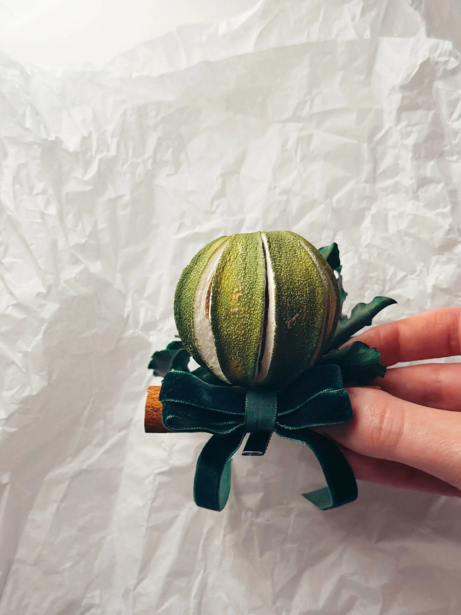 Natural Christmas baubles with dried green oranges, pittosporum foliage and cinnamon sticks with velvet ribbon handmade in London - image 3