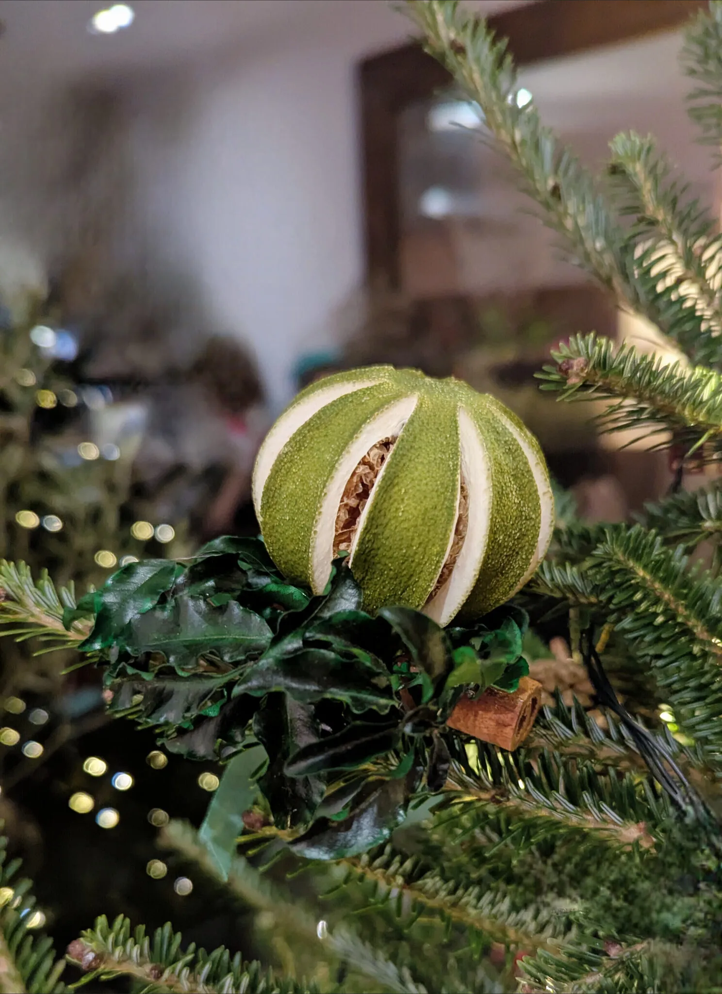 Natural Christmas baubles with dried green oranges, pittosporum foliage and cinnamon sticks with velvet ribbon handmade in London - image 4