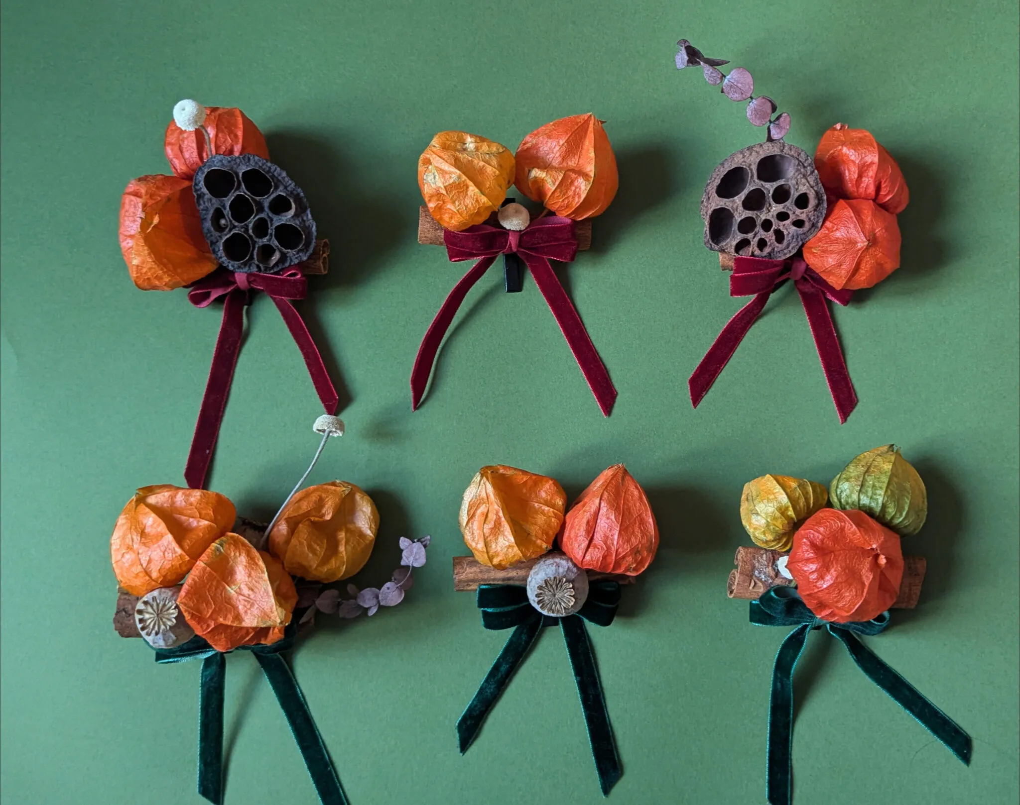 Natural Christmas baubles with physalis lanterns, lotus pods and velvet ribbon in warm rustic tones handmade in London
