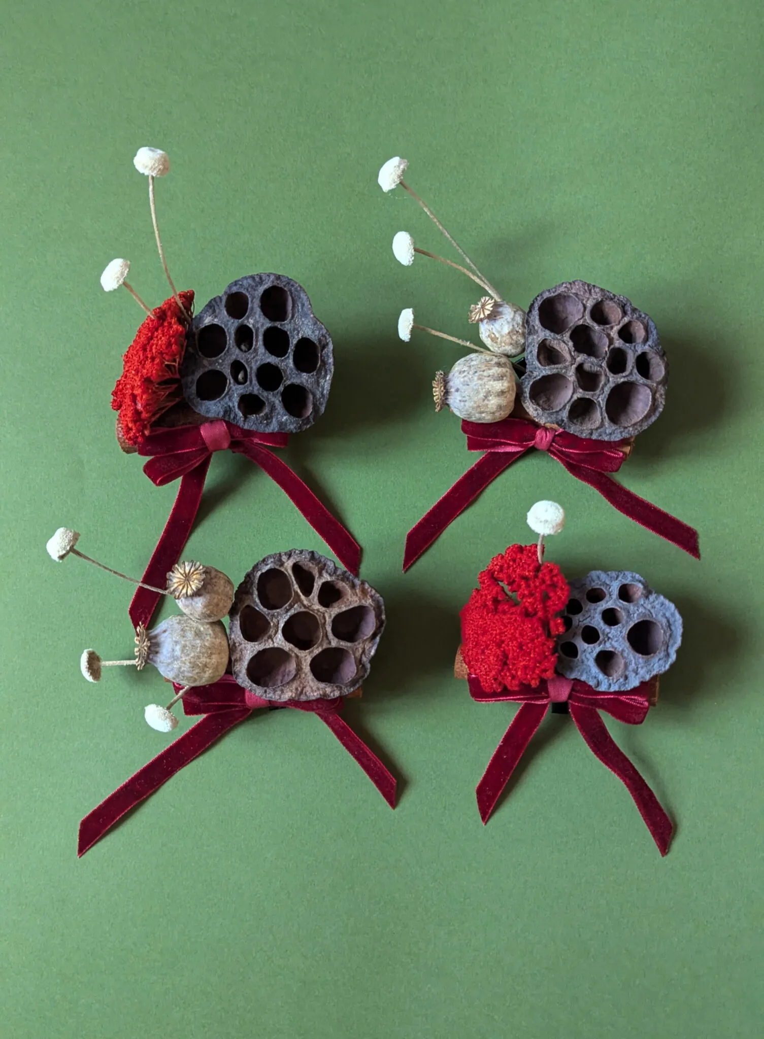 Natural lotus pod Christmas baubles with dried seed heads and burgundy velvet ribbon handmade in London