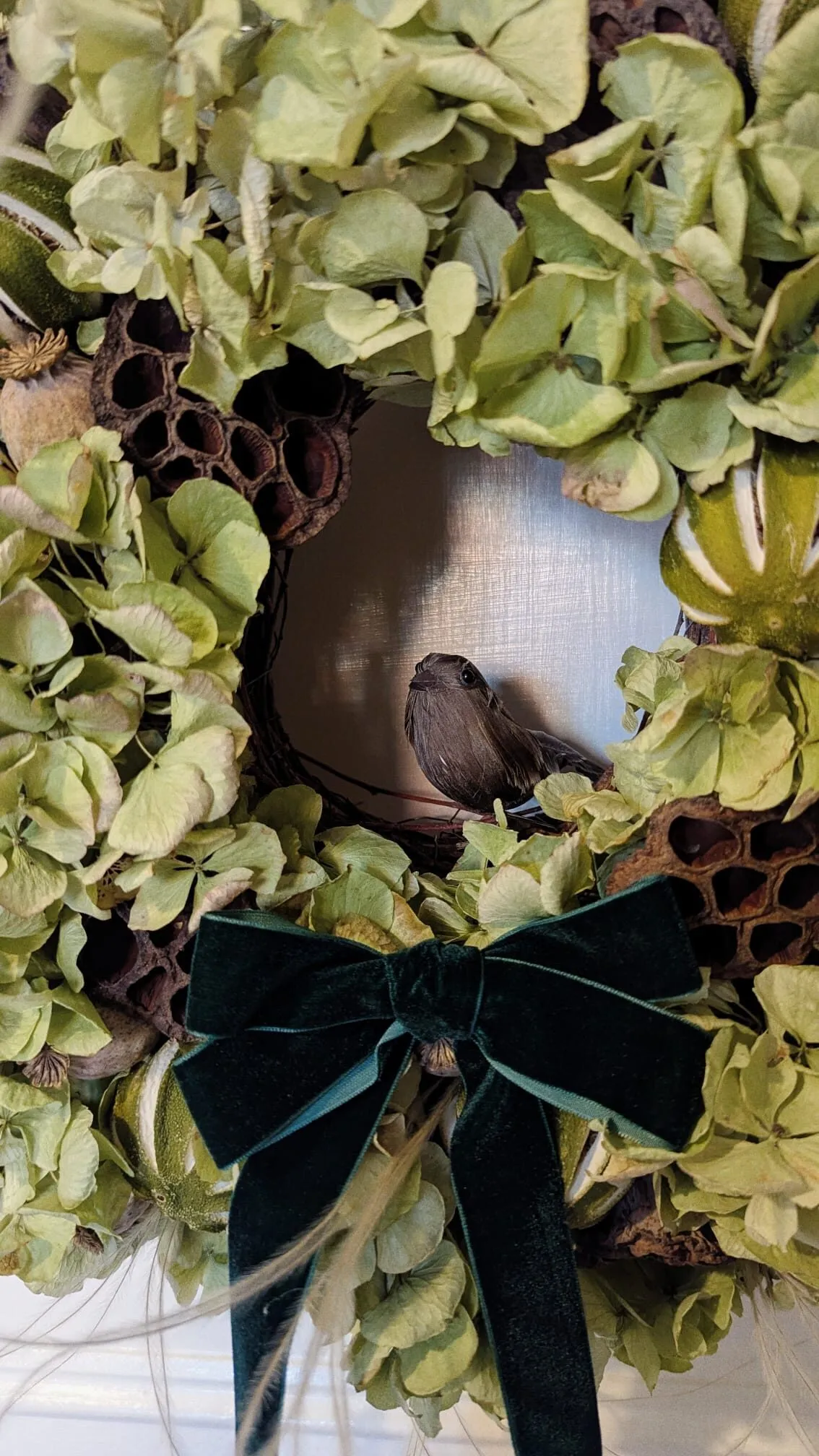 Natural green hydrangea Christmas wreath with lotus pods, poppy pods and preserved green oranges with velvet bow handmade in London - image 4