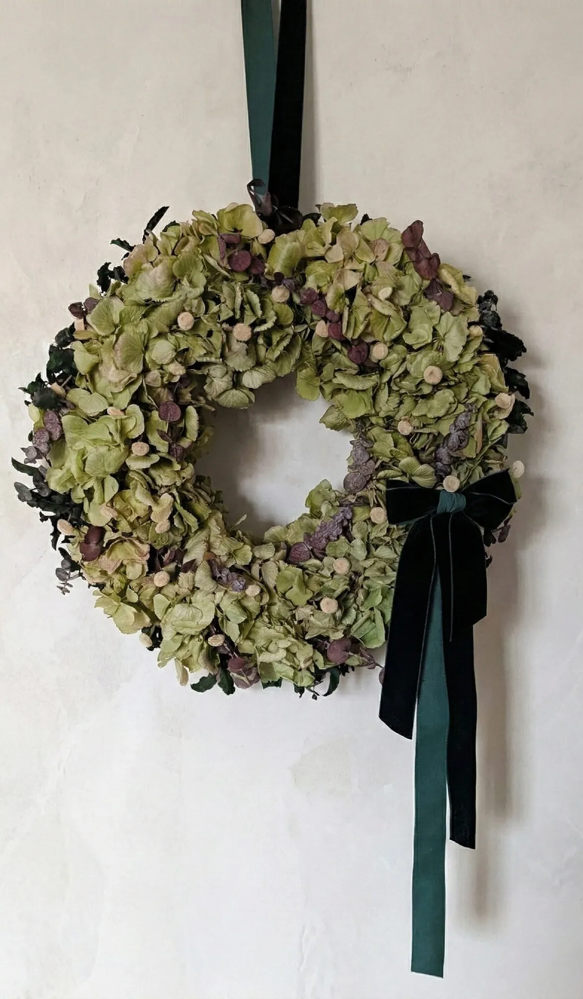 Natural green hydrangea Christmas wreath with eucalyptus and velvet bow handmade in London